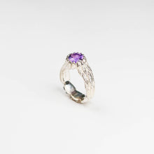 A beautiful ring from Jeremy's Feathers collection, made in solid silver and decorated with tiny hand-carved feathers that hold an 8mm round, faceted semi precious Amethyst gemstone.