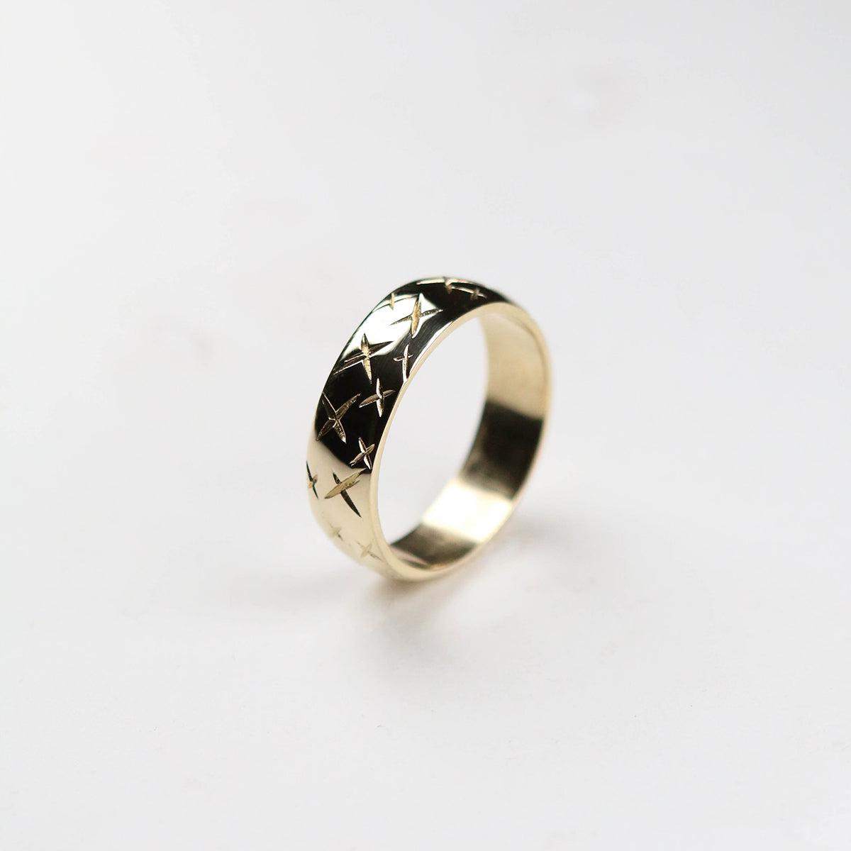 gold wedding band engraved with crosses