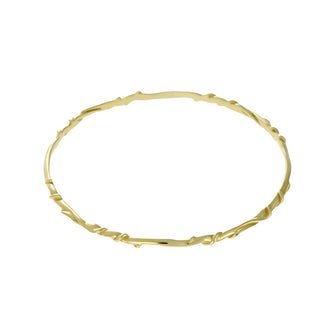 This bangle is crafted from luxurious 9ct yellow gold. It showcases a delicate, hand-twisted design that embodies elegance and intricacy. Its slender form and intricate details make it a versatile accessory, perfect for wearing alone for a subtle statement or stacked with other bangles for a more layered look.