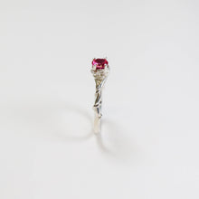 This exquisite ring, with its intricate vine design, measures a delicate 2.5mm in width. Adorning the centre is a stunning 5mm round faceted Synthetic Ruby gemstone.