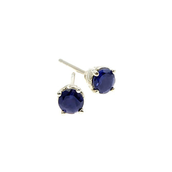These exquisite earrings, designed in Jeremy's signature Entwine style, feature delicate silver settings that embrace stunning, round, faceted semi-precious deep blue Iolite stones. Each pair of earrings is crafted to add a touch of contemporary elegance to any outfit, making them perfect for everyday wear and special occasions.