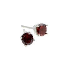 These exquisite earrings, designed in Jeremy's signature Entwine style, feature delicate silver settings that embrace stunning, round, faceted semi-precious rich red Garnet stones. Each pair of earrings is crafted to add a touch of contemporary elegance to any outfit, making them perfect for everyday wear and special occasions.