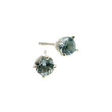 These exquisite earrings, designed in Jeremy's signature Entwine style, feature delicate silver settings that embrace stunning, round, faceted semi-precious serene Sky Blue Topaz stones. Each pair of earrings is crafted to add a touch of contemporary elegance to any outfit, making them perfect for everyday wear and special occasions.