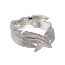 A standout piece from Jeremy's Feathers collection, this ring boasts intricately overlapping silver feathers that create a sense of movement and grace.