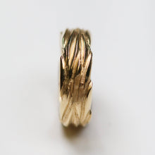 This gold ring measures 7.5mm in width.