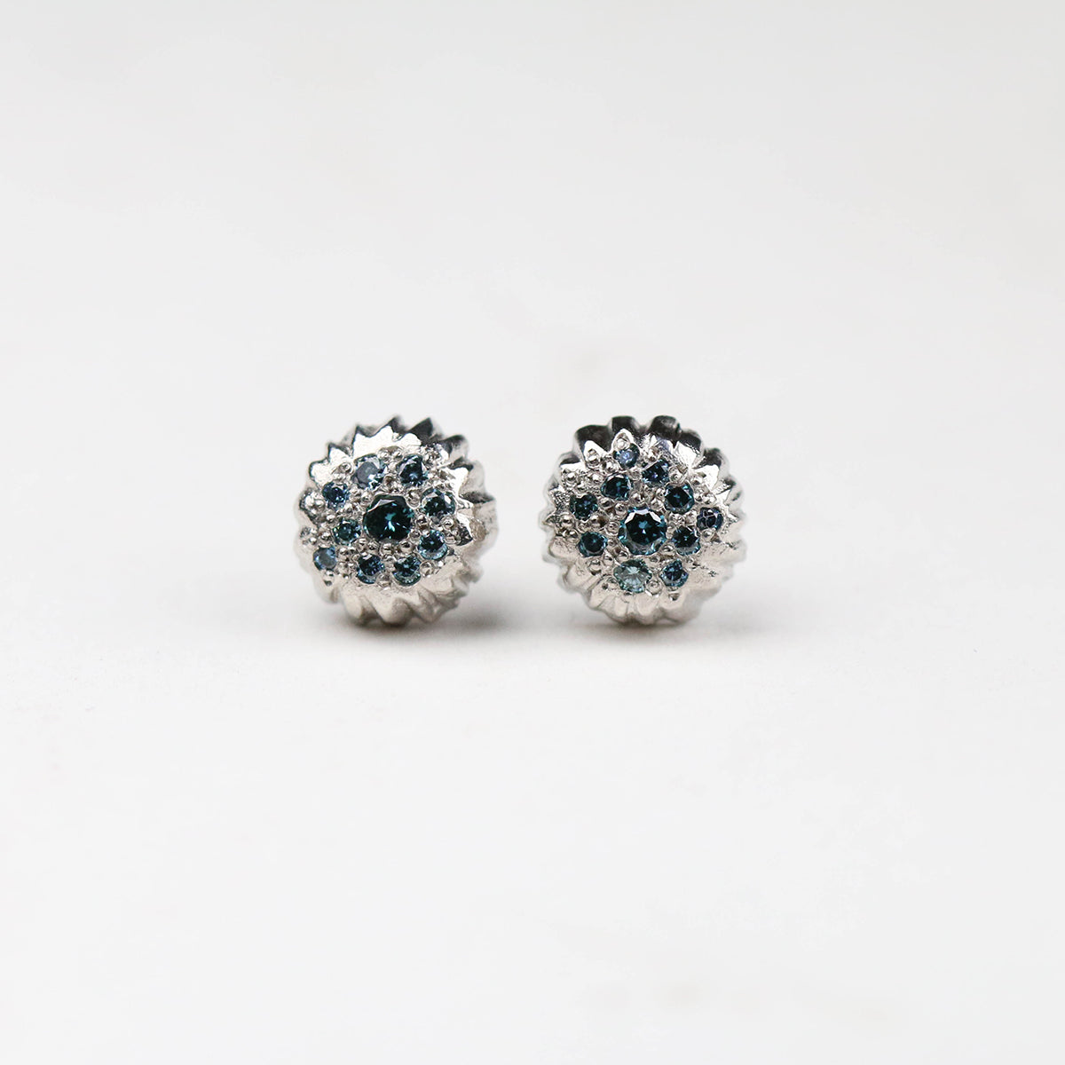 Forest, platinum pavé set cluster hand carved earrings, set with treated blue diamonds.