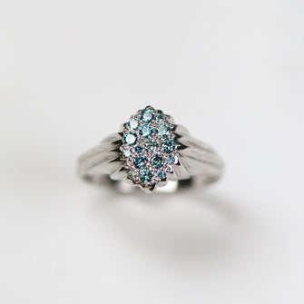 Forest, platinum pavé set cluster hand carved ring, set with .30pt treated blue diamonds.