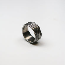 This silver ring measures 10mm in width.