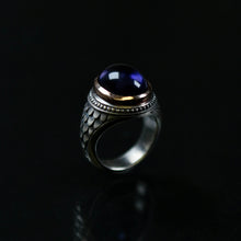 This silver college style ring is handmade in solid silver with a 9ct rose gold setting and oval cabochon amethyst.