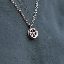 This Five Spoke Wheel pendant measures 17mm in diameter, and hangs on a 20" medium weight curb link chain.