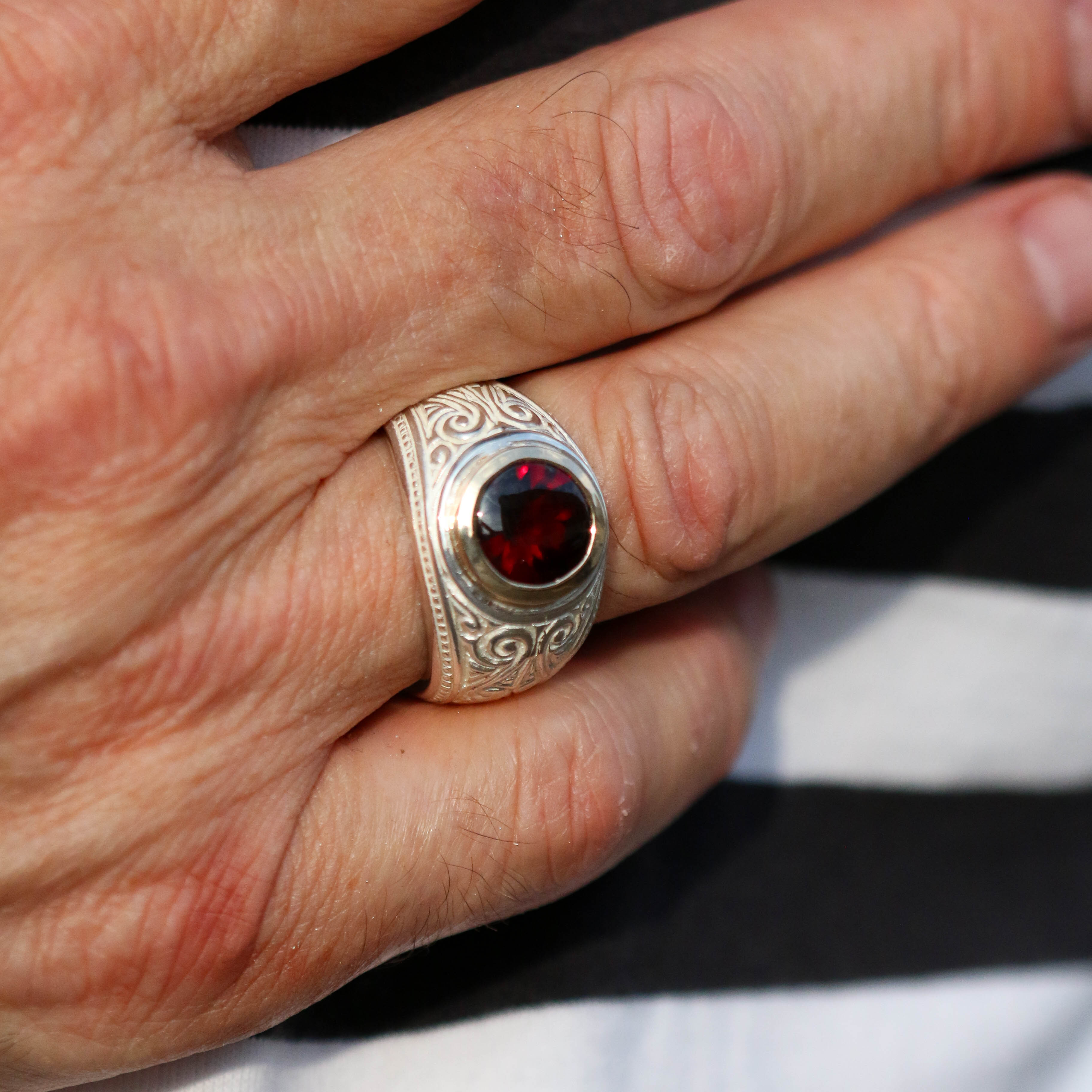 A brand new piece by Jeremy Hoye. This silver college style ring is handmade in solid silver with a 9ct yellow gold setting and oval garnet stone.