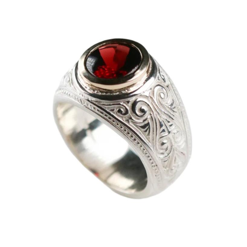 A brand new piece by Jeremy Hoye. This silver college style ring is handmade in solid silver with a 9ct yellow gold setting and oval garnet stone.