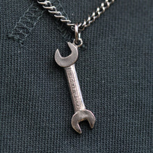 This classic spanner silver pendant measures 32mm in diameter, and hangs on a 20" medium weight curb link chain.