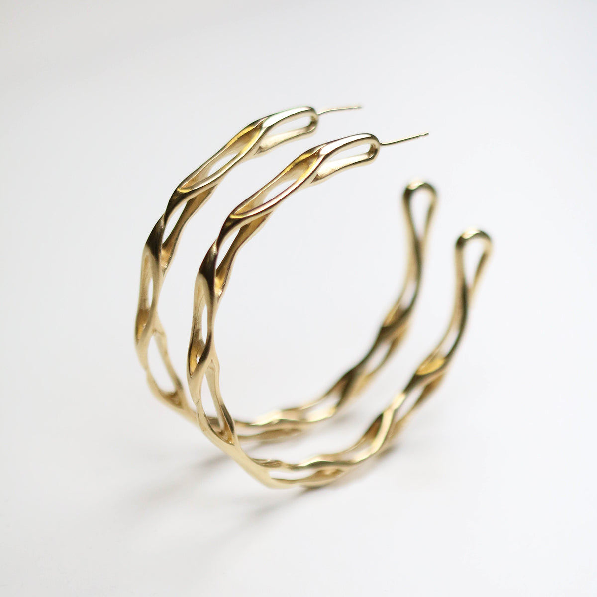 Handmade in silver 9ct gold plating, these earrings measure 50mm in circumference.