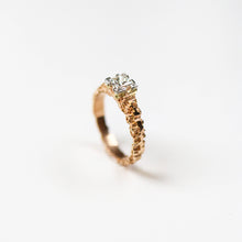 This unique solitaire is hand carved in 18ct rose gold, and set in platinum with a beautiful .56pt princess cut diamond.