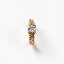 This unique solitaire is hand carved in 18ct rose gold, and set in platinum with a beautiful .56pt princess cut diamond.