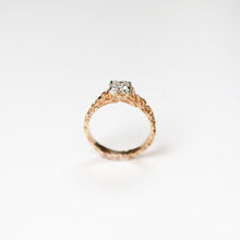 This unique solitaire is hand carved in 18ct rose gold, and set in platinum with a beautiful .56pt princess cut diamond.