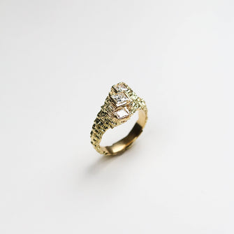 This unique ring holds three diamond, the centre stone holds a 40pts diamond and two either side holds .18pts.