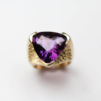 This unique solitaire is hand carved in 9ct yellow gold set with a beautiful 18 carat amethyst stone.