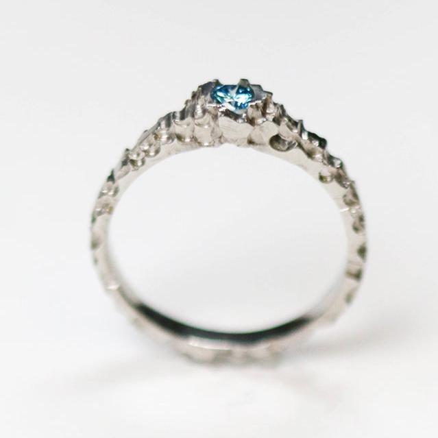 The luna platinum solitaire is hand carved and set with a beautiful .20pt princess cut diamond.