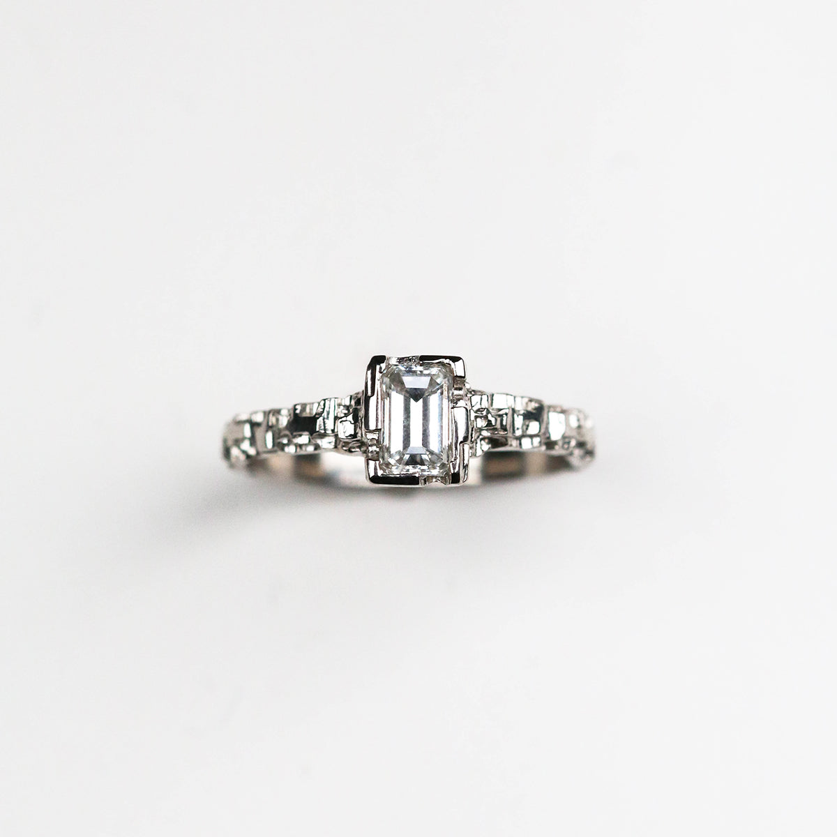  Hand-carved platinum solitaire, featuring a sleek 2mm band and a stunning .50pt diamond. 