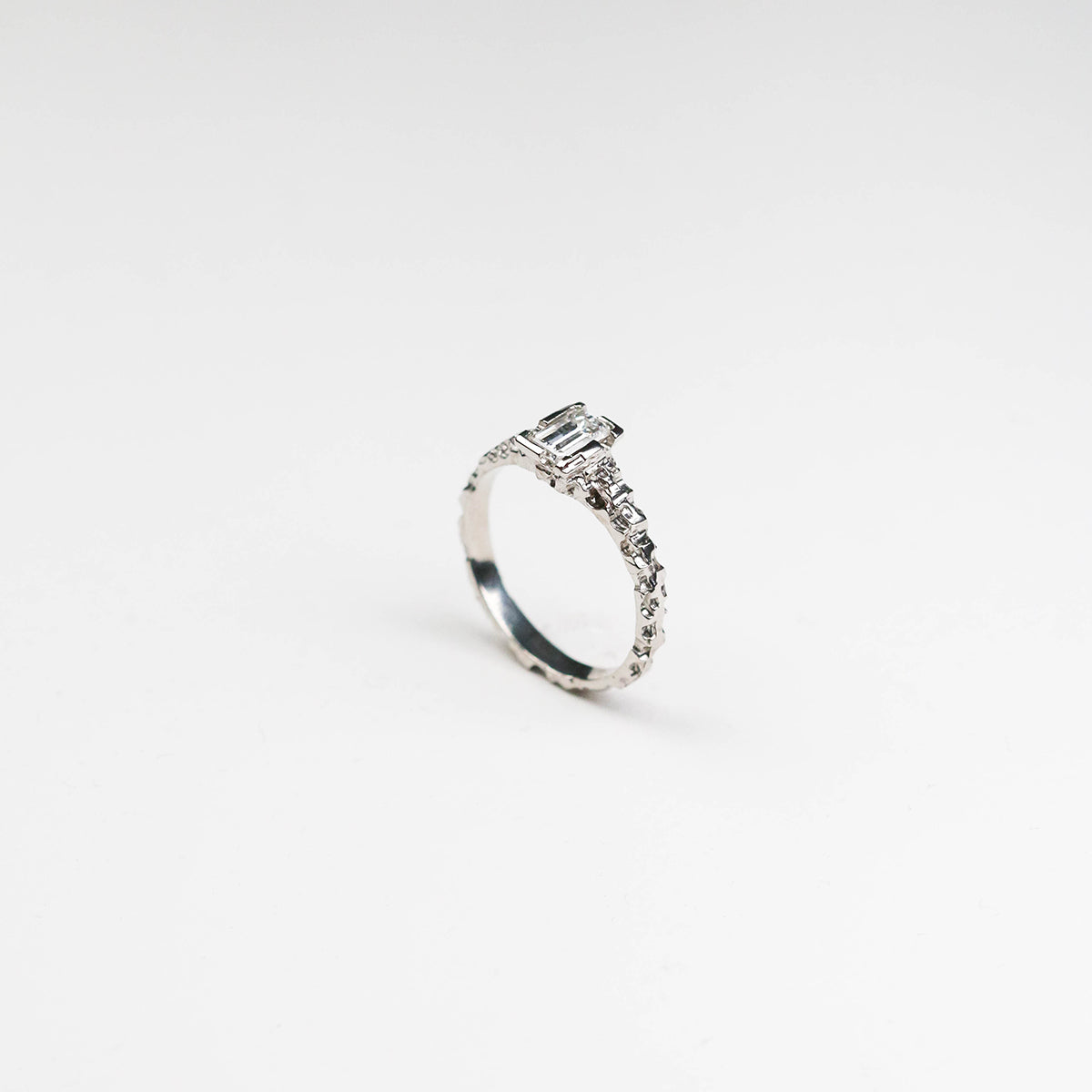  Hand-carved platinum solitaire, featuring a sleek 2mm band and a stunning .50pt diamond. 