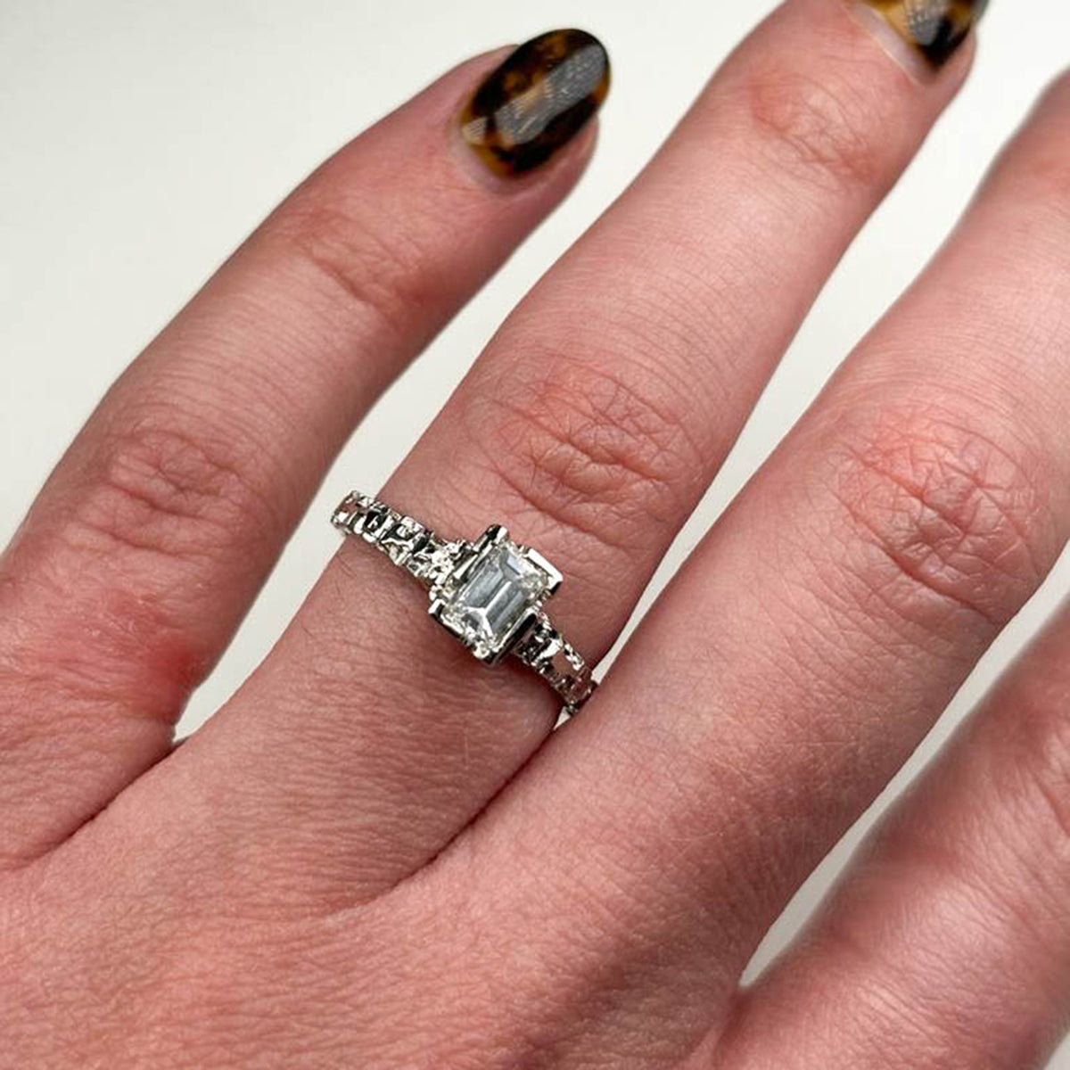  Hand-carved platinum solitaire, featuring a sleek 2mm band and a stunning .50pt diamond. 