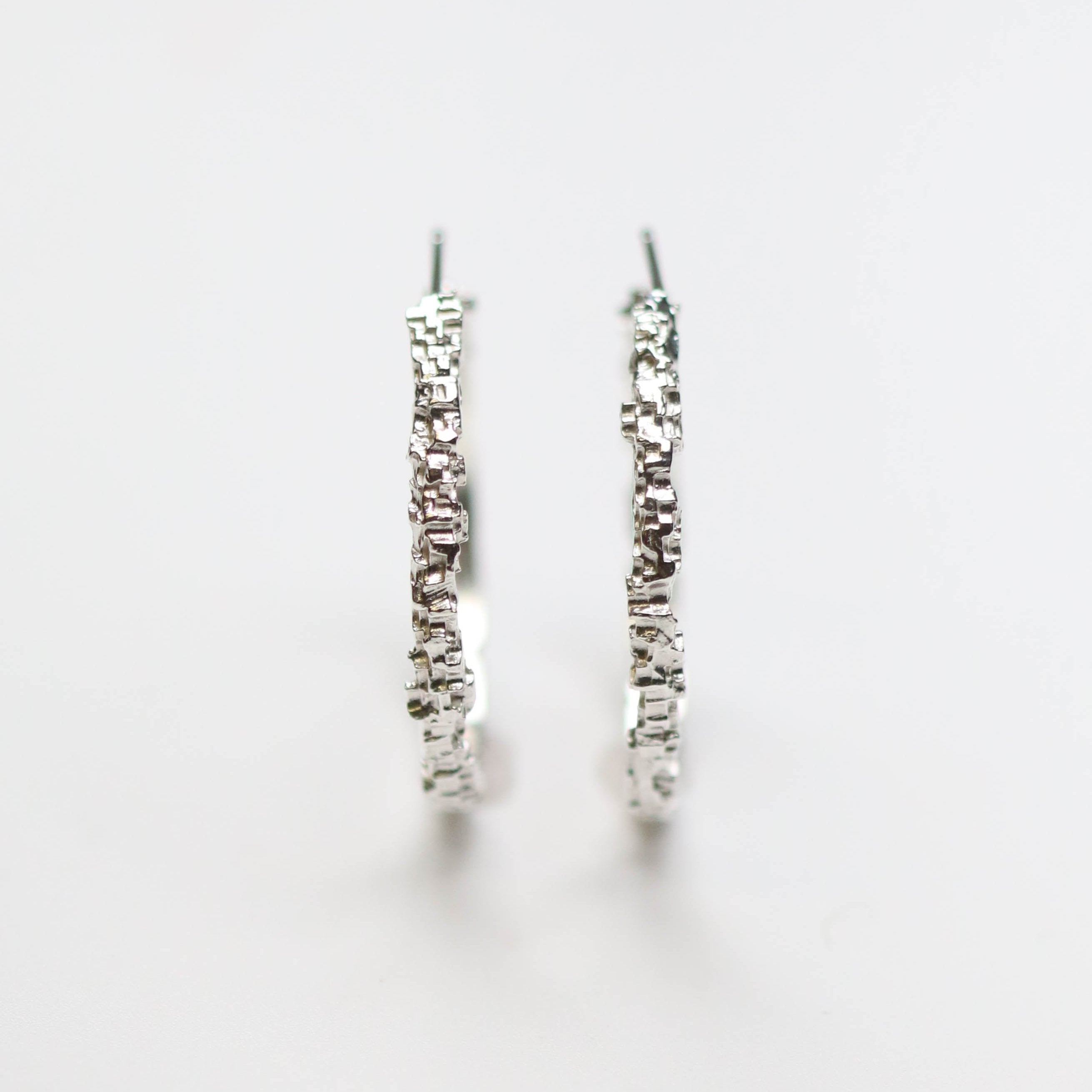 Luna silver textured hoops. Handmade in sterling silver, these earrings measure at 30mm circumference with a 3mm width.