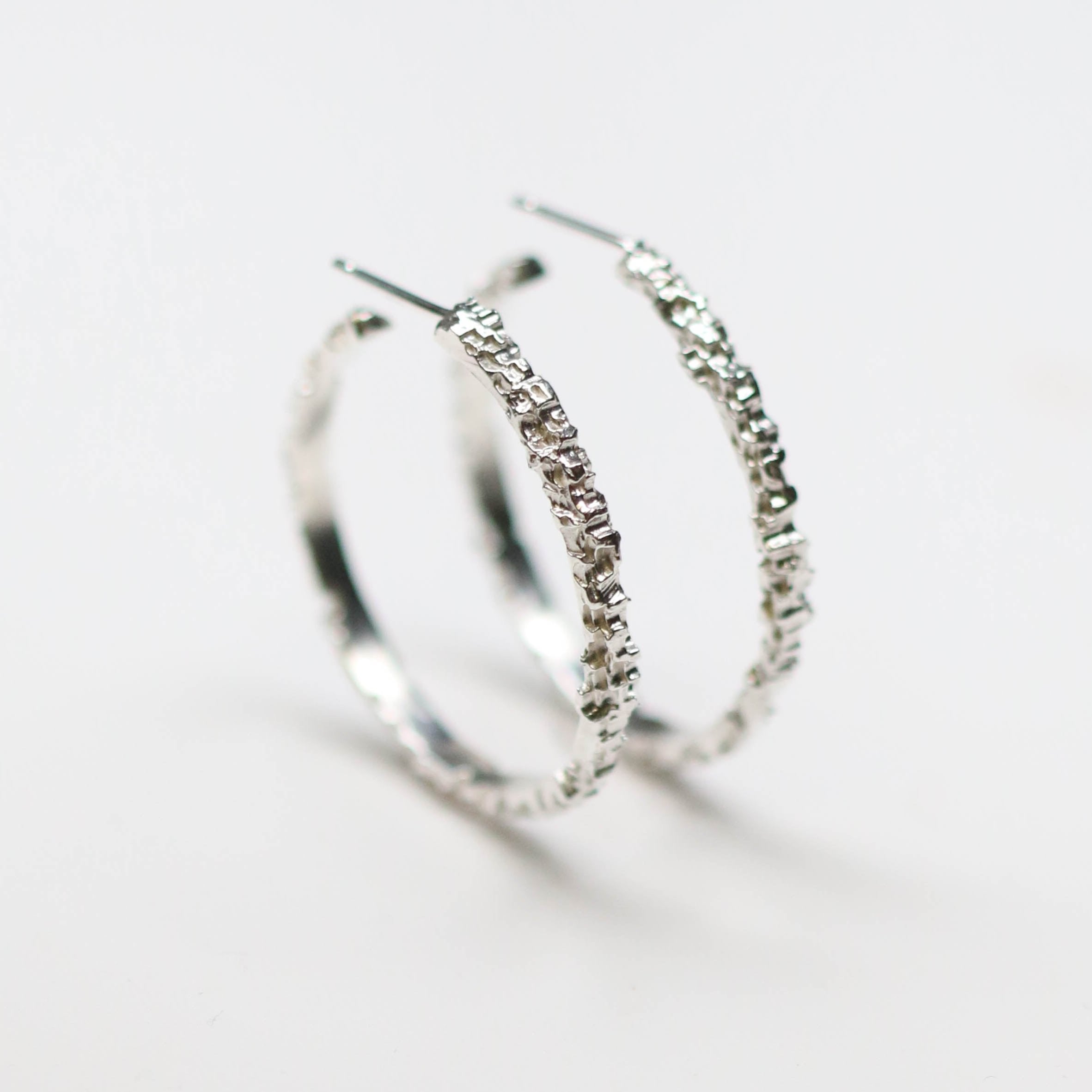 Luna silver textured hoops. Handmade in sterling silver, these earrings measure at 30mm circumference with a 3mm width.