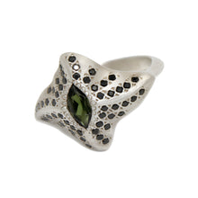 The ring features a central marquise green tourmaline and 13 pavé set black cubic zirconia on each wing plate to maximise sparkle from every angle. This unusual silver cocktail ring sits fairly flat to the finger, which makes it comfortable and wearable.