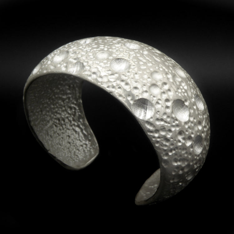 Measuring 36mm at its widest point, this piece is hand-detailed to resemble the texture of Lunar craters.