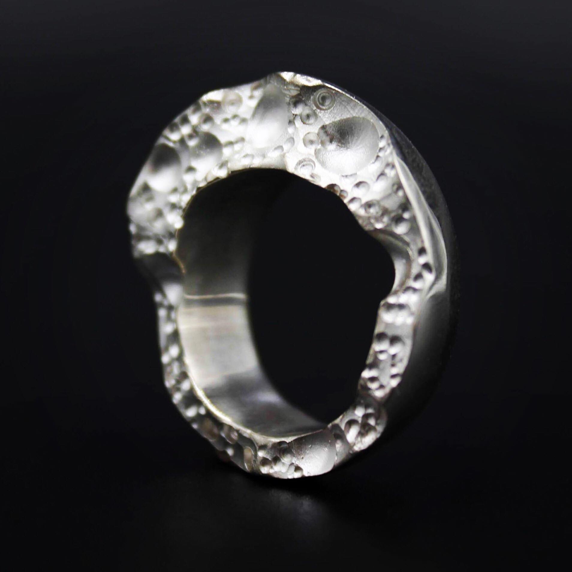 This handmade silver ring measures 7.5mm at its highest point and tapers down to 3.5mm. Finished with unique textured detail and a contrasting smooth, polished surface.