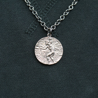 This St. Christopher pendant measures 25mm in diameter, and hangs on a 20" medium weight curb link chain.