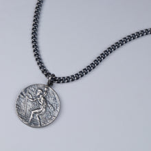 This St. Christopher pendant measures 25mm in diameter, and hangs on a 20" medium weight curb link chain.