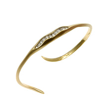 This bracelet is handmade in 18ct gold and pavé set with 12 white diamonds that total .20pts.