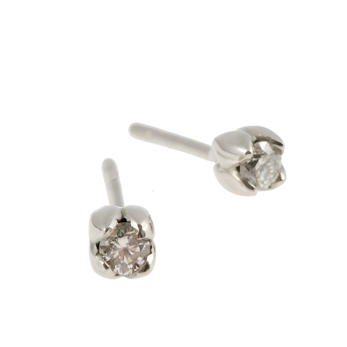 Handmade in 18ct white gold, each stud features four tiny petals which hold a round, brilliant cut white diamond weighing .15pts of a carat.