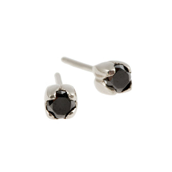 Two stunning round, brilliant cut .25pt treated Black diamonds sit delicately in a tulip petal setting.