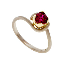 A simple fine band handmade in 18ct white gold with contrasting yellow gold petal setting. Set with .50pt ruby, this piece has been designed to fit with a choice of three wedding rings, each creating a different look.
