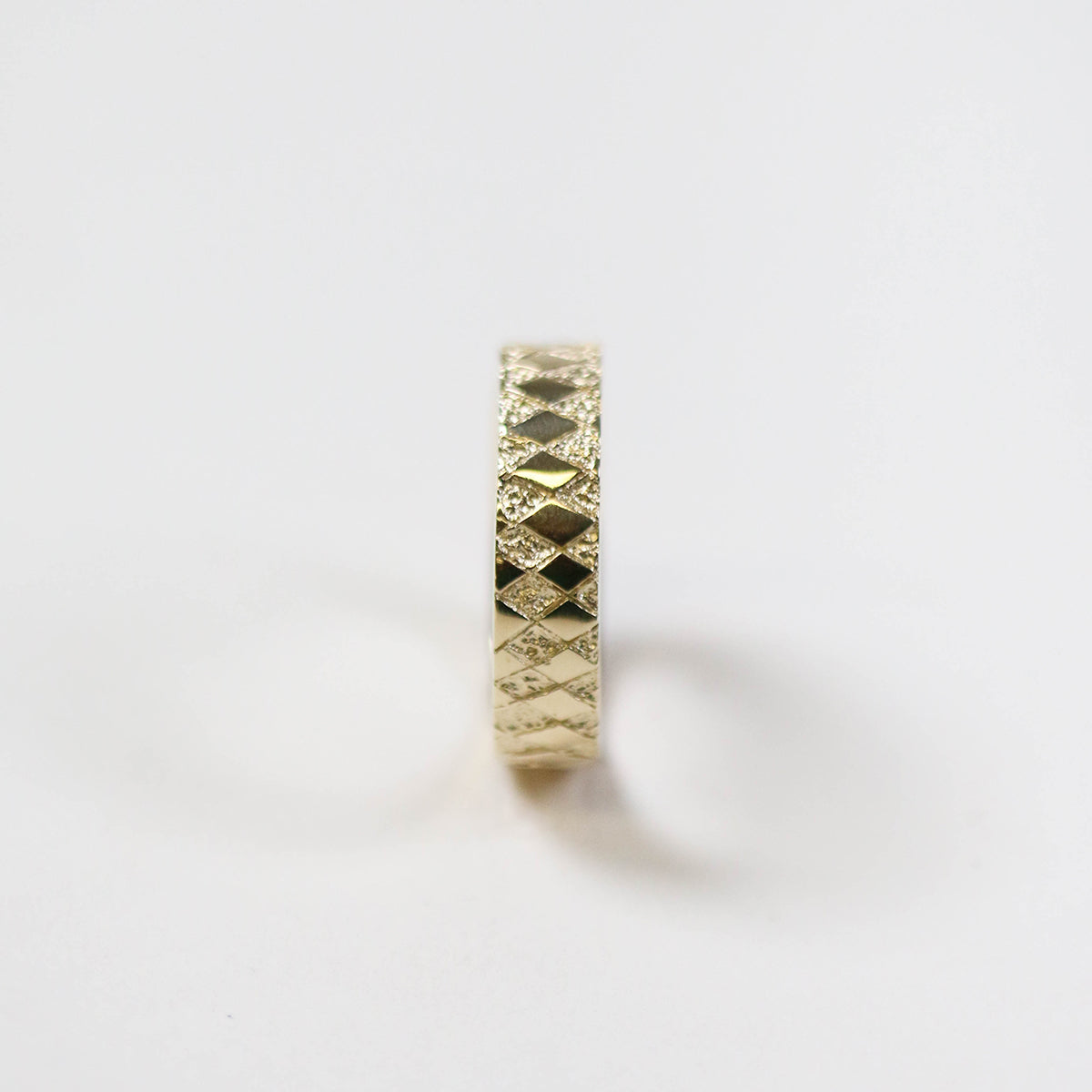 gold ring with chequered pattern - side view